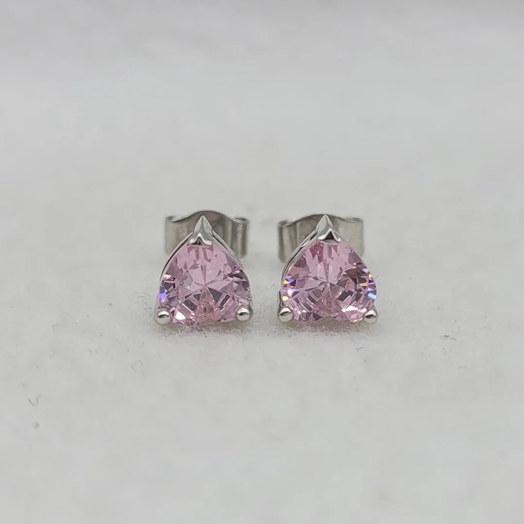 Heart shaped pink sapphire earrings close up