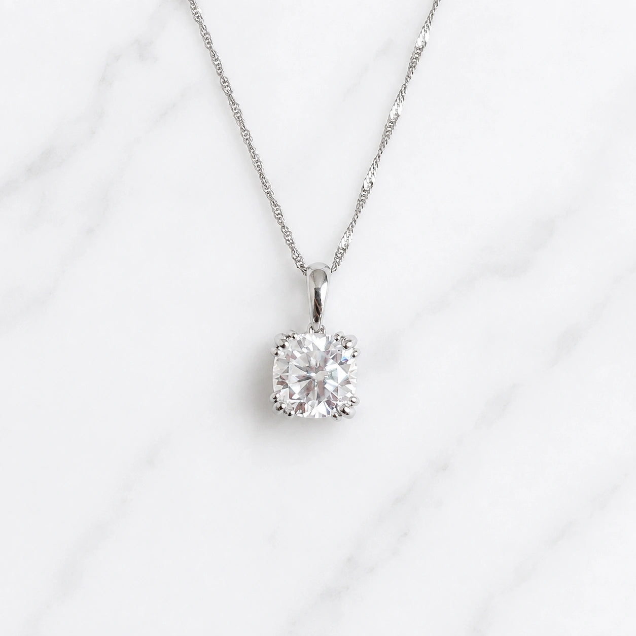Front view of 3 carat cushion moissanite pendant set in 18k solid gold double prong basket